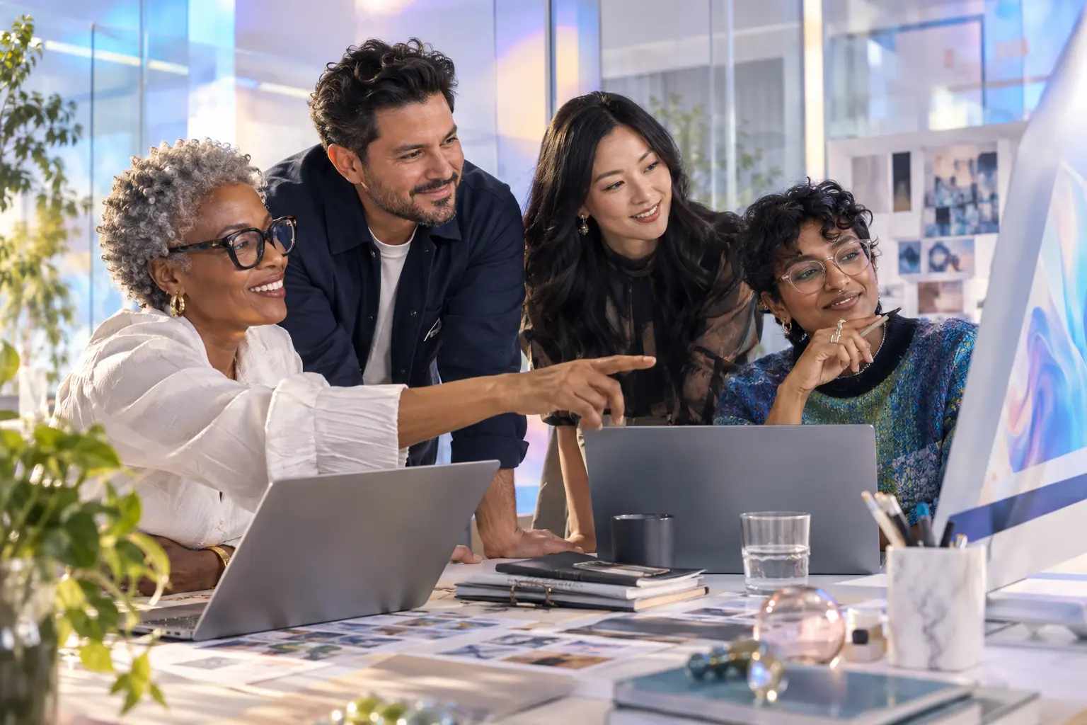 Four diverse agency professionals using GloryXOS together